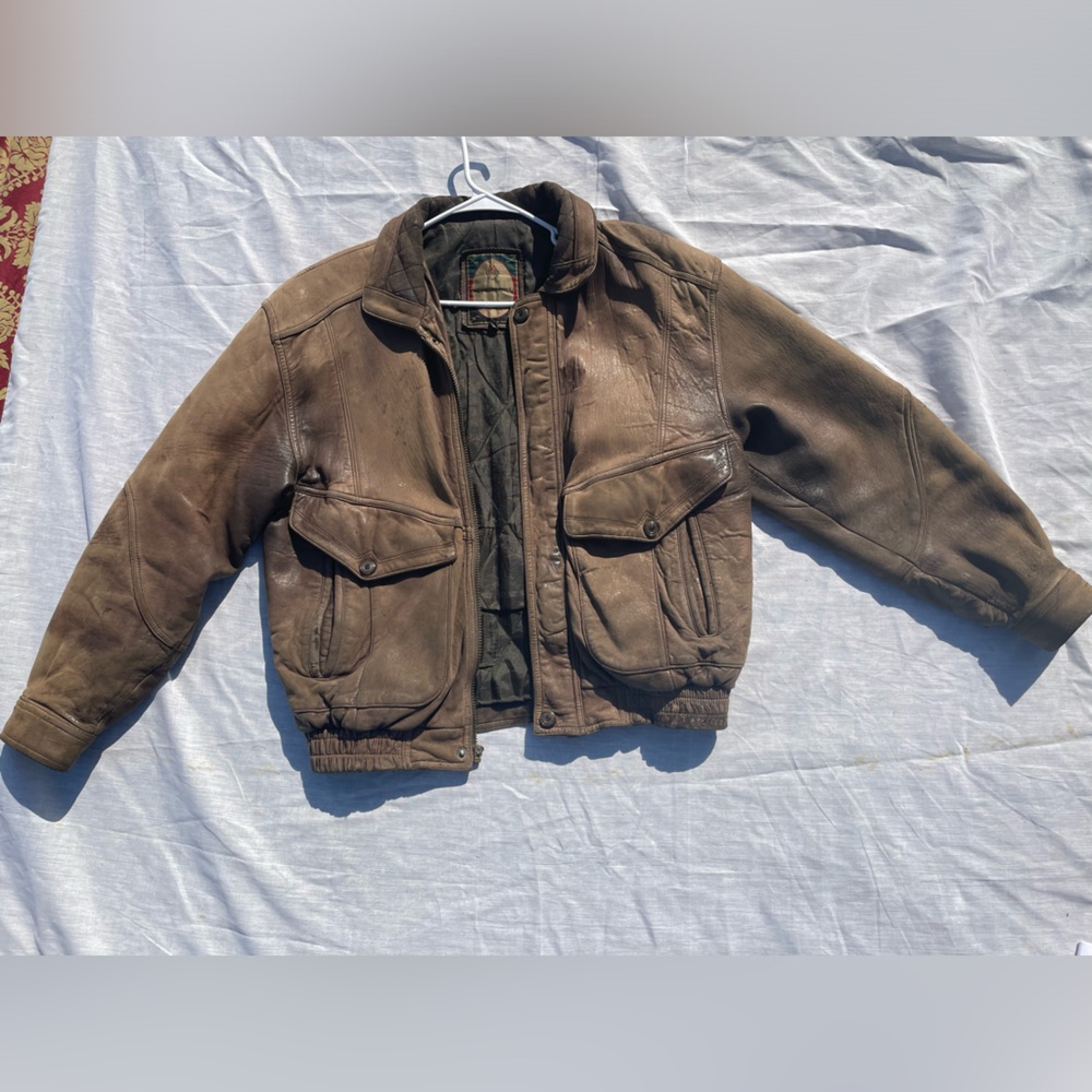 worn “members only” vintage brown leather jacket.